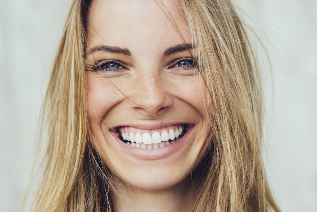 Non-invasive periodontal procedures keep a young woman's smile healthy.