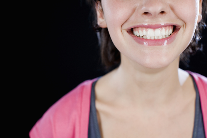 Women smiling after cosmetic gum surgery.